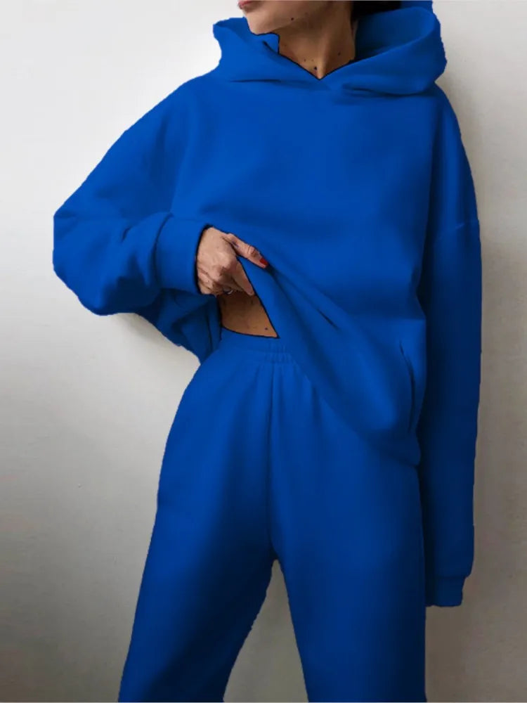 Ensemble décontracté deux pièces pour femme automne-hiver – sweat à capuche épaissi avec poches et pantalon de sport assorti. Tenue mode, ample et confortable.