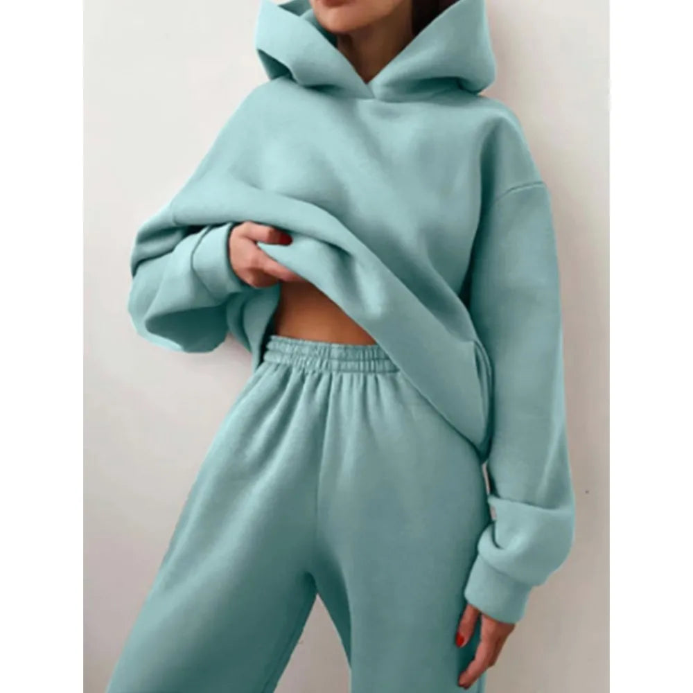 Ensemble décontracté deux pièces pour femme automne-hiver – sweat à capuche épaissi avec poches et pantalon de sport assorti. Tenue mode, ample et confortable.
